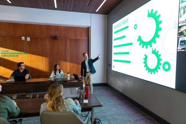 a man giving a presentation to a full room